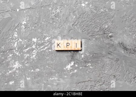 kpi word written on wood block. key performance indicators text on table, concept. Stock Photo