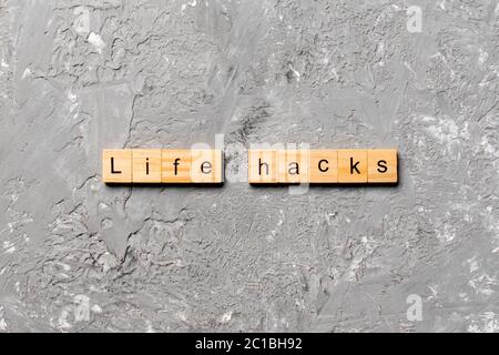 life hacks word written on wood block. life hacks text on table, concept. Stock Photo