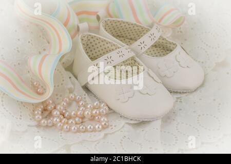 Baptism or birthday invitation background for baby girl with pink pearls, white shoes and ribbon on Stock Photo