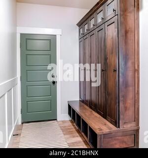 Square Hinged panelled wooden fire door with black knob and lock inside a home Stock Photo