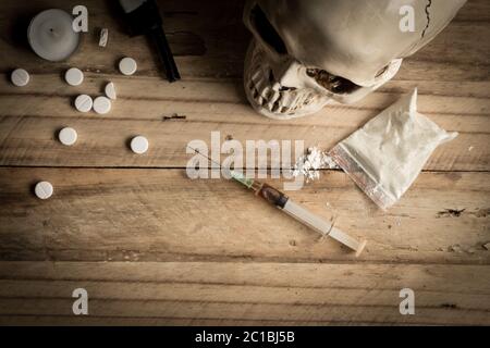 Drugs, powder, syringe and tablets on rustic wooden background. Drug addiction concept background wi Stock Photo