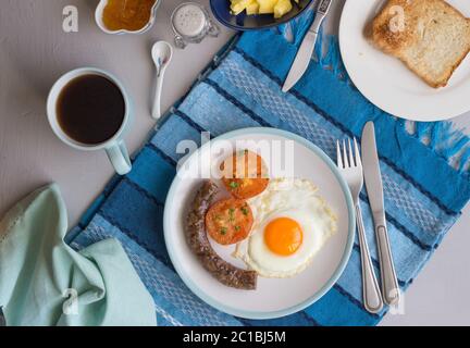 Top view breakfast background with sausage, fried egg, tomato, coffee, marmalade and toast Stock Photo