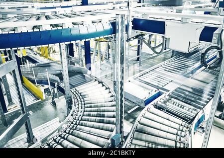 Conveyor roller transportation line, color toned picture. Stock Photo