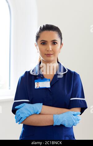 Portrait of nurse wearing stretch vinyl gloves Stock Photo