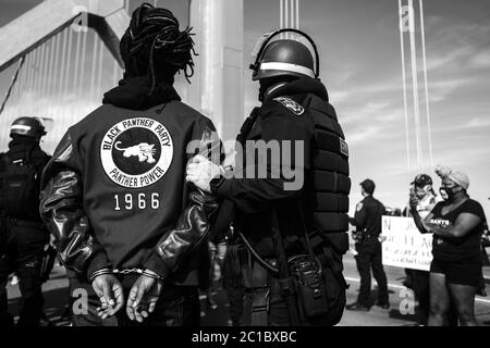 San Francisco, United States. 14th June, 2020. SAN FRANCISCO, CA- JUNE 14: A protestor is arrested during the shut down of the westbound direction of the Bay Bridge toward San Francisco, California on June 14, 2020 after the death of George Floyd. (Photo by Chris Tuite/ImageSPACE) Credit: Imagespace/Alamy Live News Stock Photo