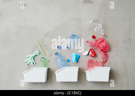 High angle view of three containers for garbage isolated on grey background Stock Photo