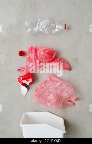 Close-up of bags and plastic bottles sorting in plastic container isolated on grey background Stock Photo
