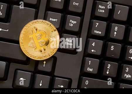 Bitcoin on black computer keyboard Stock Photo