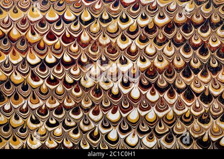 Abstract repetitive pattern of paper marbling on a worn endpaper used inside an 1890 book cover Stock Photo