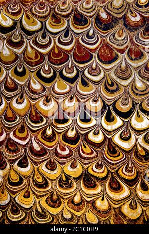 Abstract repetitive pattern of paper marbling on a worn endpaper used inside an 1890 book cover Stock Photo