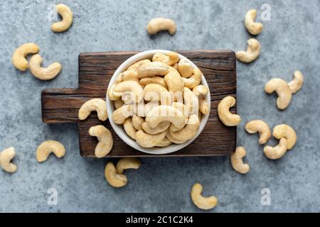 Cashew nuts in bowl top view. Healthy raw nuts of cashew fruit Stock Photo