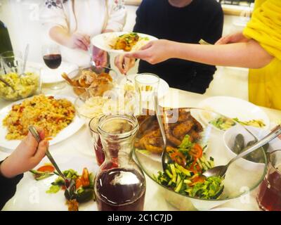 Family having dinner together sitting at the wooden table Stock Photo