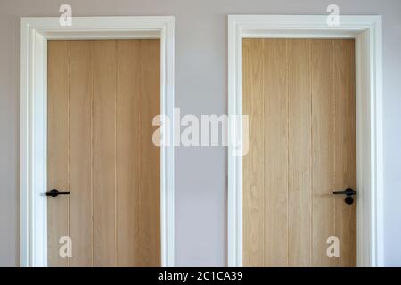 Close Up Of Two Wooden Doors In Modern House Symbolizing Choice Stock Photo