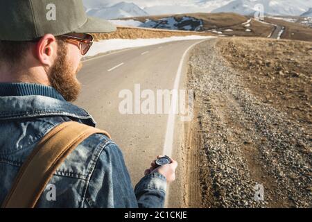 Close-up Hipster man using a compass on a snowy mountain Stock Photo