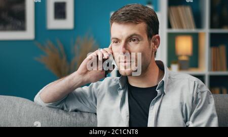 Positive man talking on cellphone Stock Photo