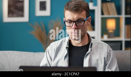 Man using laptop in flat Stock Photo