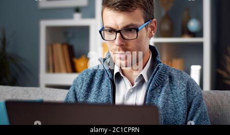 Focused man using laptop Stock Photo