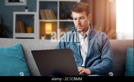 Serious man using laptop Stock Photo