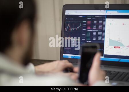 Office world, time brake. Businessman working at the wood table with new business project. Man touching screen modern mobile pho Stock Photo