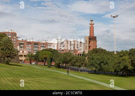 Man riding bicycle through park and green area in city of Cartagena in region Murcia in Spain Stock Photo