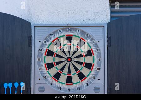 Target view of darts hanging on the wall of the terrace. Fun concept Stock Photo