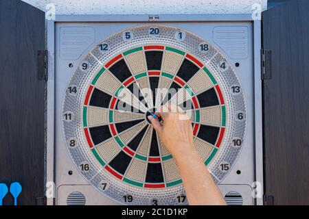 Target view of darts hanging on the wall of the terrace. Fun concept Stock Photo