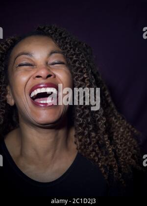 Vertical portrait of an Afro American woman laughing Stock Photo