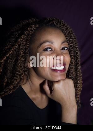 vertical portrait of an Afro American woman looking proud, happy and confident Stock Photo