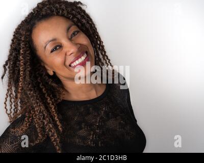 horizontal portrait of a joyful Afro American woman wearing an elegant see through sweater Stock Photo