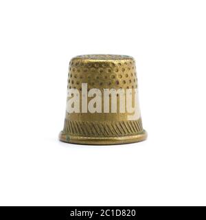 Old copper thimble close-up isolated on white background Stock Photo