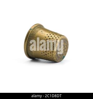 Old copper thimble close-up isolated on white background Stock Photo