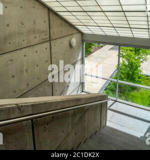 Square crop Commercial building interior with slanted frosted glass roof over staircase Stock Photo