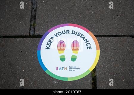 Non essential shops reopen in Bath after 12 weeks of being shut with social distancing measures in place.  Keep your distance sticker - Covid 19, UK Stock Photo