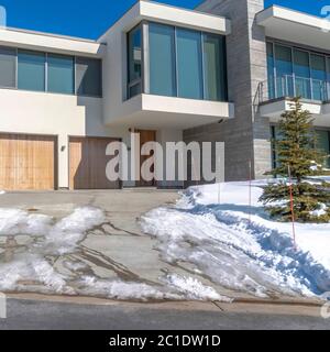 Square Facade of a modern home on a snowy hill neighborhood in Park City Utah in winter Stock Photo