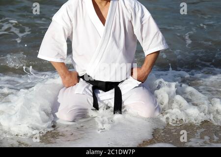 Japanese karate martial arts, spiritual sitting at the beach Stock Photo