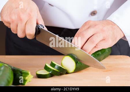 Chef cutting some delicious and healthy courgettes Stock Photo