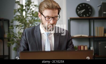 Serious businessman working on laptop Stock Photo