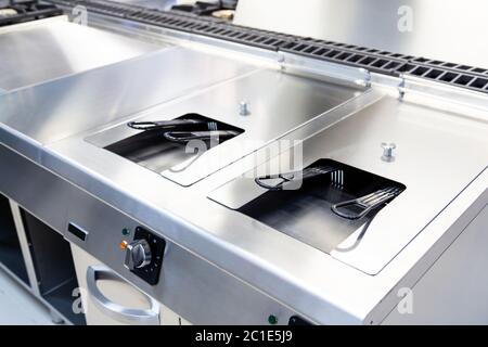 Industrial fryer built in stainless in a kitchen Stock Photo
