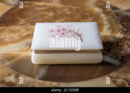 An old beautiful marble box with an engraved flower on the lid in oriental style. Western Europe. End of the 19th century Stock Photo