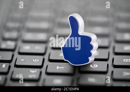 Thumb Up graphic illustration on laptop keyboard Stock Photo