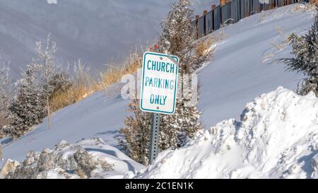 Panorama Building and Church Parking Only sign on the snowed in slope of Wasatch Mountain Stock Photo