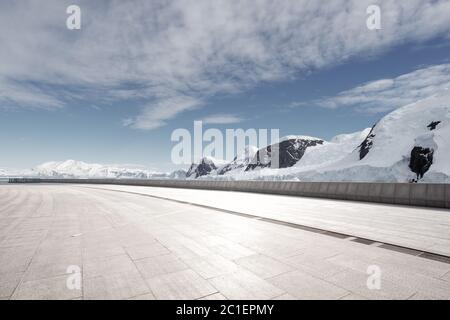 empty brick ground with sonw mountain as background Stock Photo