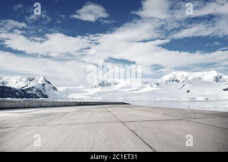empty brick ground with sonw mountain as background Stock Photo