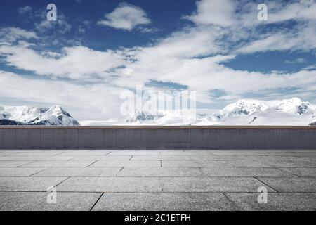 empty brick ground with sonw mountain as background Stock Photo
