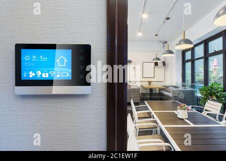 smart home app in control panel in modern restaurant Stock Photo