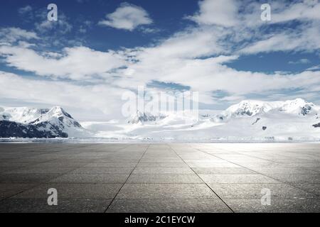 empty brick ground with sonw mountain as background Stock Photo