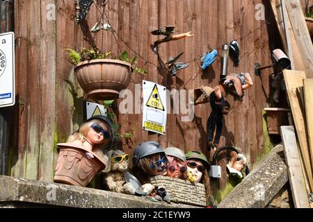 Discarded heads, toys and dismembered dolls decorate the fence of a garden in the small town of  Frome in Somerset Stock Photo