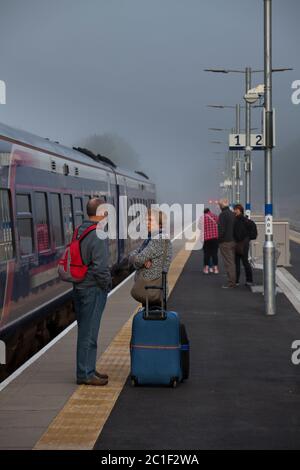 Rail passengers waiting for the first train of the day at Tweedbank railway station at the end of the borders railway on a Sunday morning Stock Photo