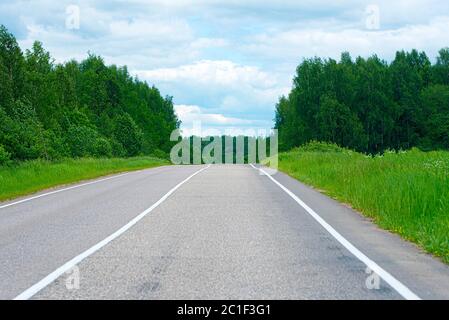 Empty asphalt road empty road between green trees in Russia, summer landscape Stock Photo