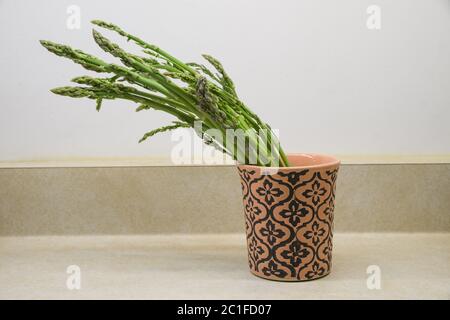 fresh wild asparagus spears on a counter in a cup Stock Photo